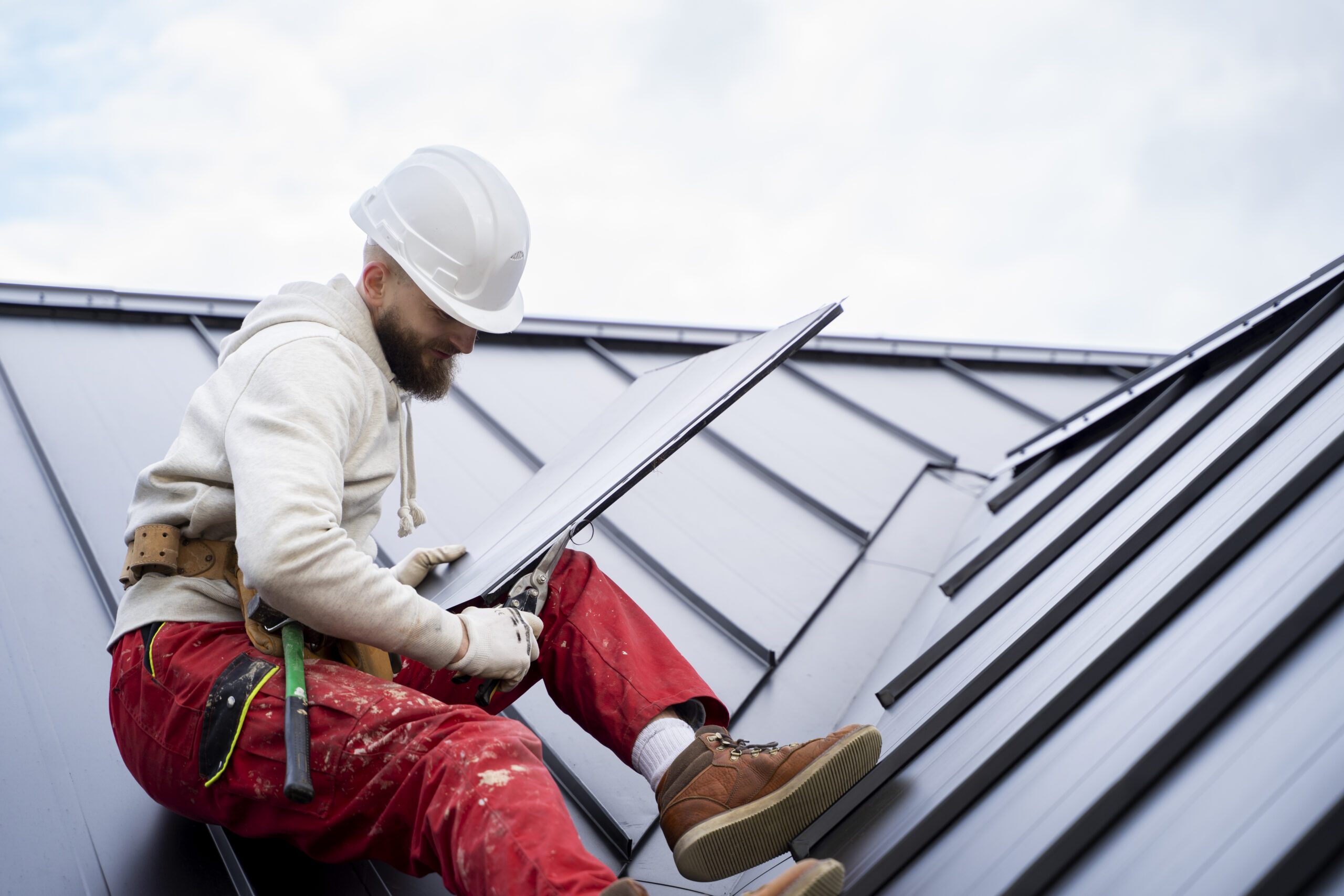 man with helmet working roof full shot